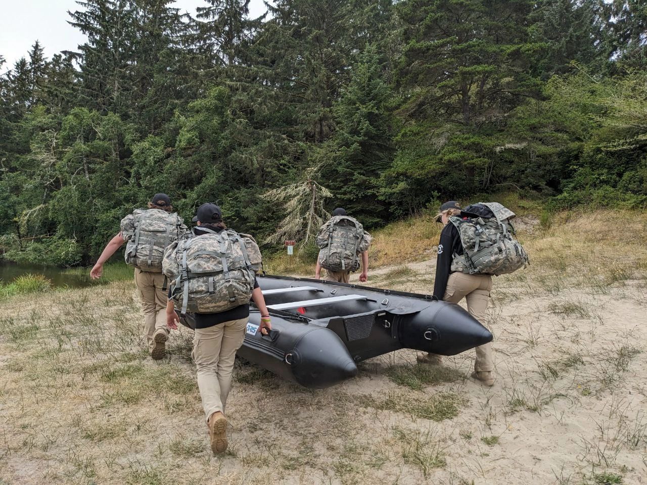 Team carrying boat military exercise
